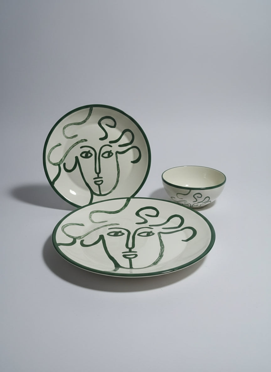 Green and white logo with abstract face design on a reflective surface