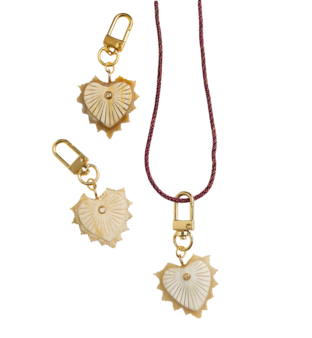Heart-shaped keychain with gold and beige design on a white background