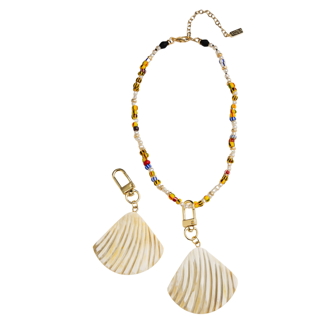 Bracelet with shell charms and beaded details on a white background