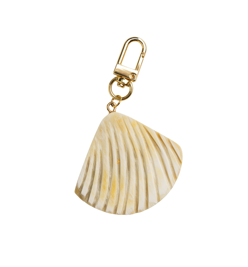 Shell-shaped keychain with gold clasp on a white background