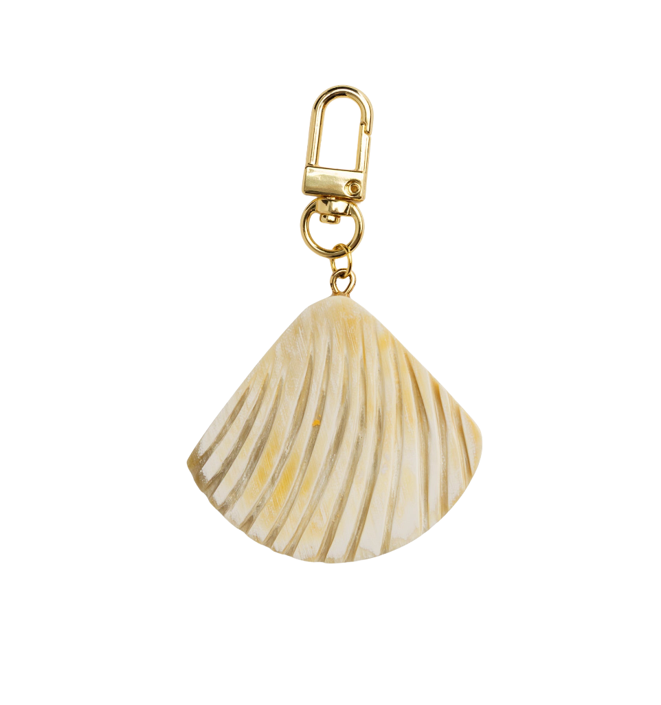 Shell-shaped keychain with gold clasp on a white background