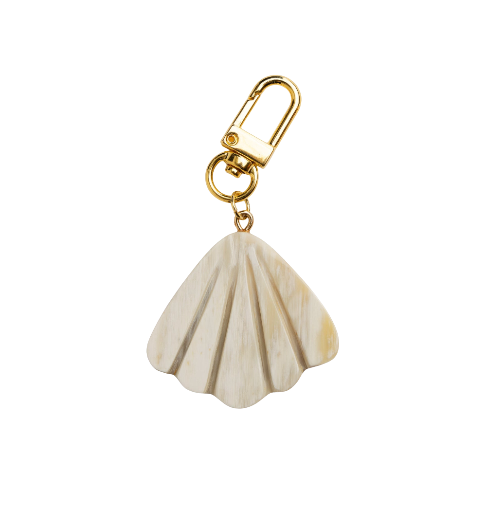 Shell-shaped keychain with gold clasp on a white background