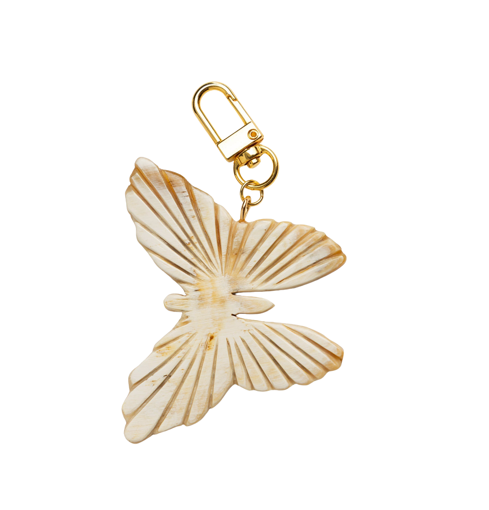 Butterfly-shaped charm with gold clasp on a white background