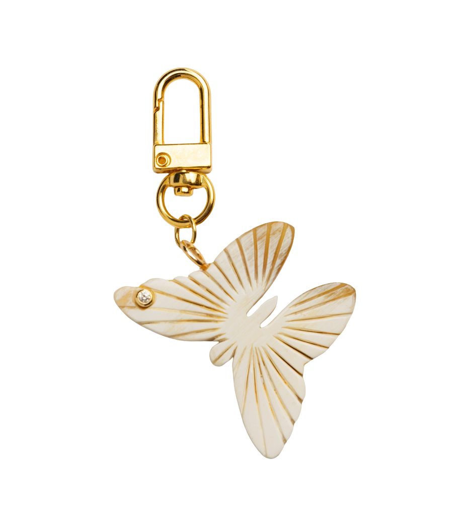 Butterfly-shaped charm with gold accents on a white background