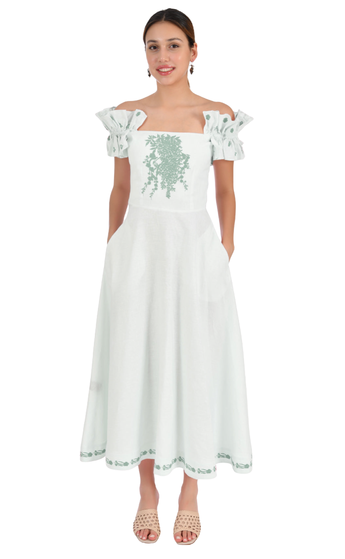 Woman wearing a light green dress with green embroidery