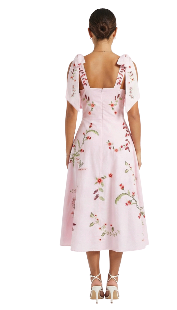 Pink floral dress with sheer sleeves on a white background