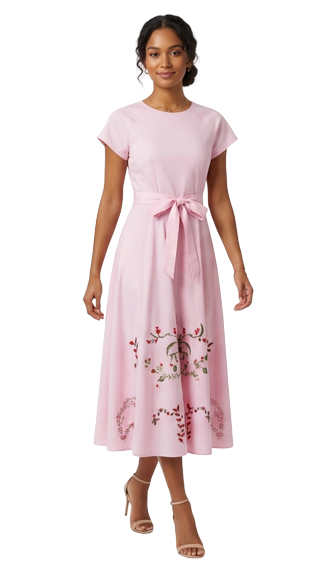 Woman wearing a pink dress with floral embroidery on a white background