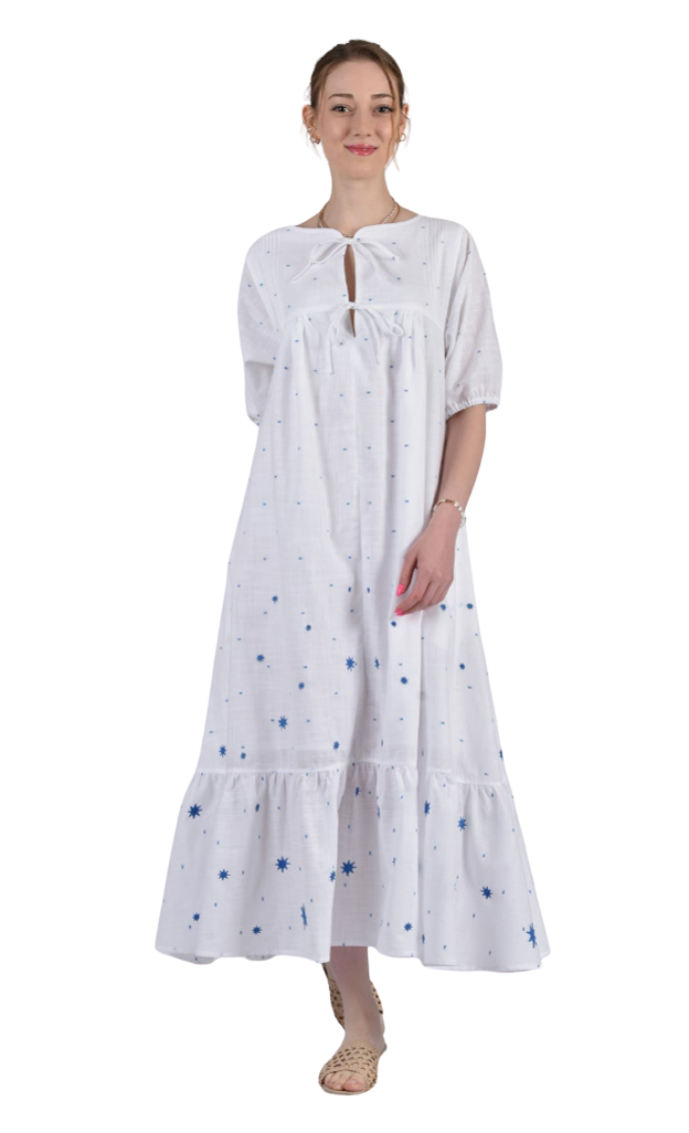 Woman wearing a white dress with blue patterns on a white background