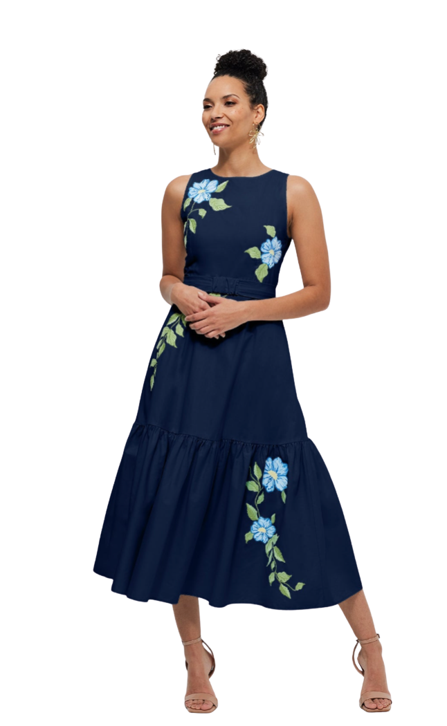 Woman wearing a navy blue dress with floral embroidery on a white background