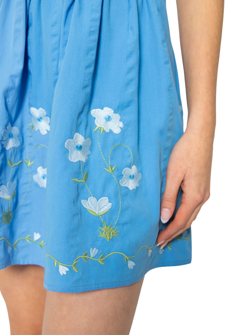 Blue dress with floral embroidery on a white background