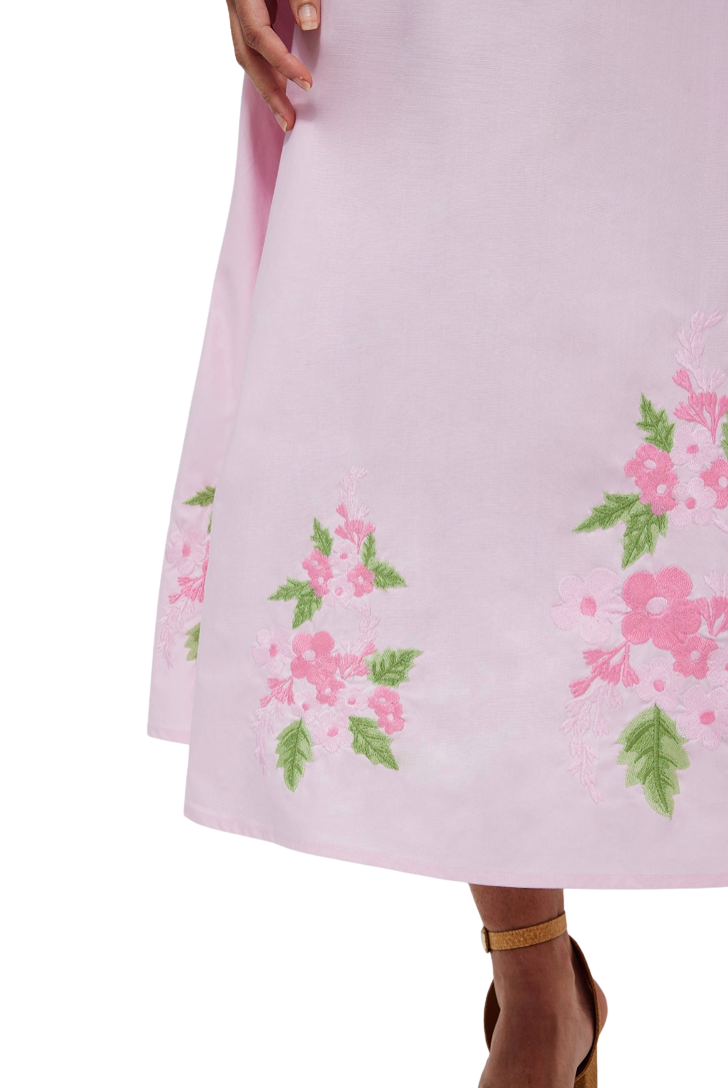 Light pink dress with floral embroidery on a white background