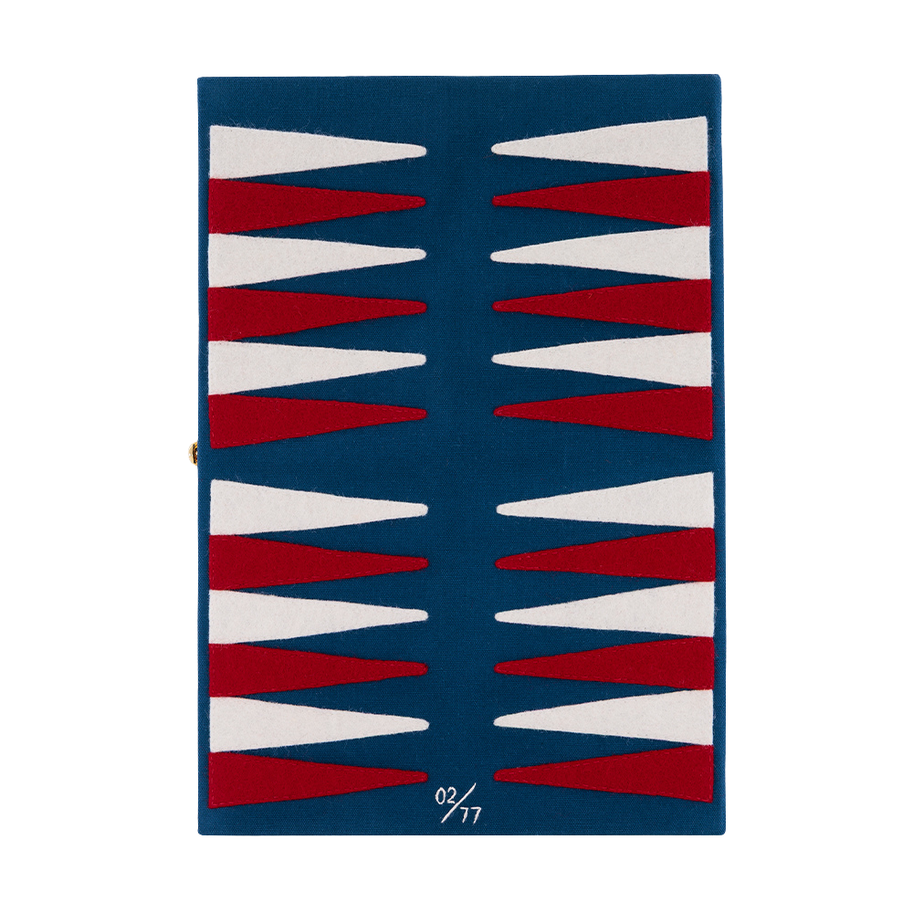A rectangular navy blue rug with a geometric backgammon-inspired pattern of alternating red and white triangles, shown flat against a white background.