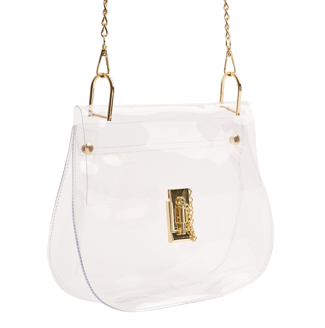 A clear vinyl shoulder bag with gold-tone hardware, featuring a chain strap and a decorative gold clasp on the front.