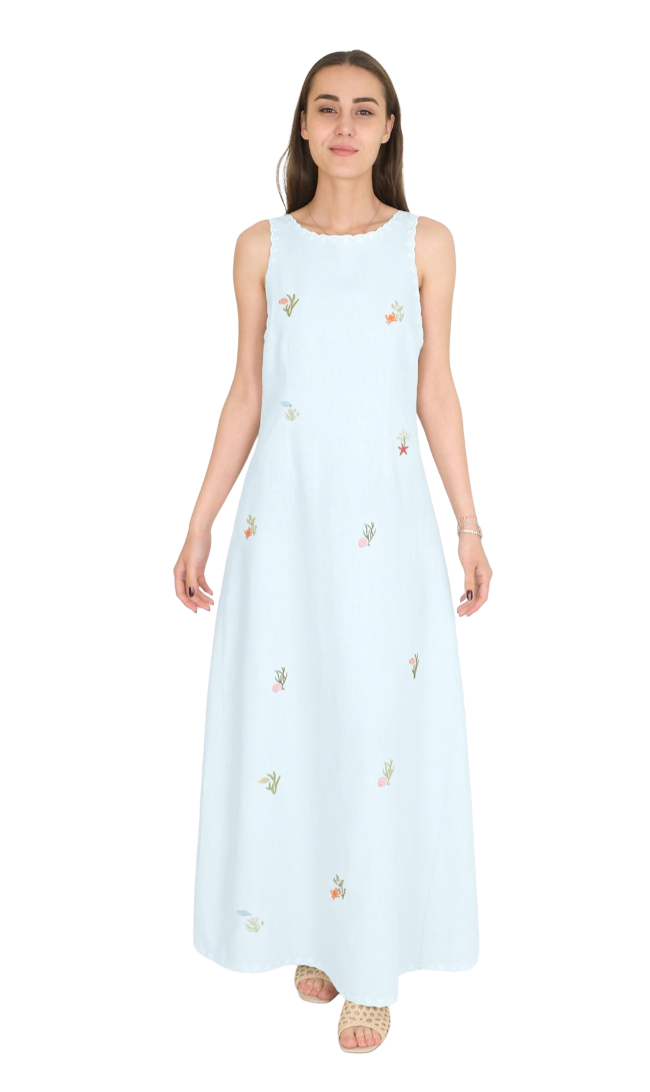 Woman wearing a light lagoon blue sleeveless dress with embroidery