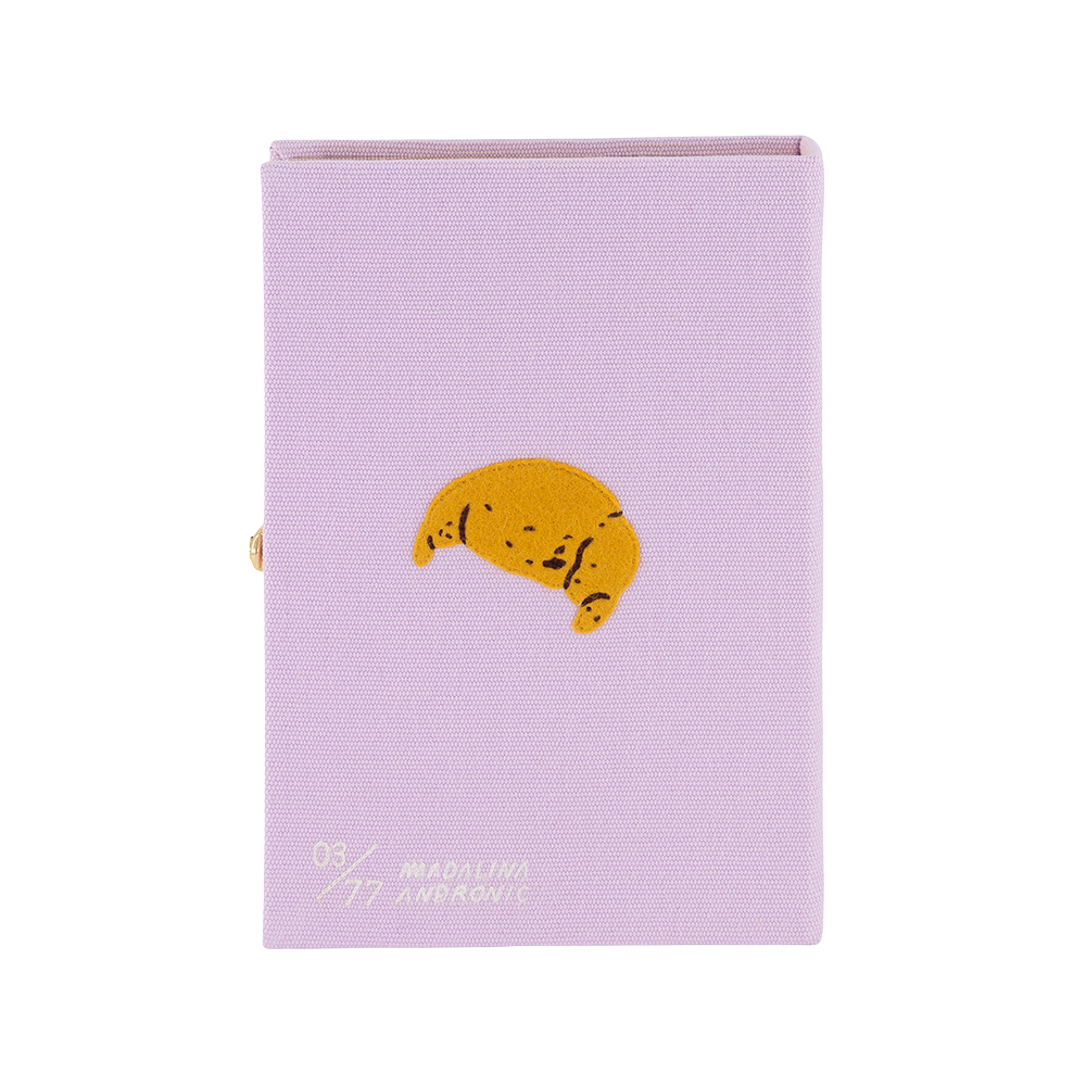 Purple notebook with a yellow crescent moon design on a white background