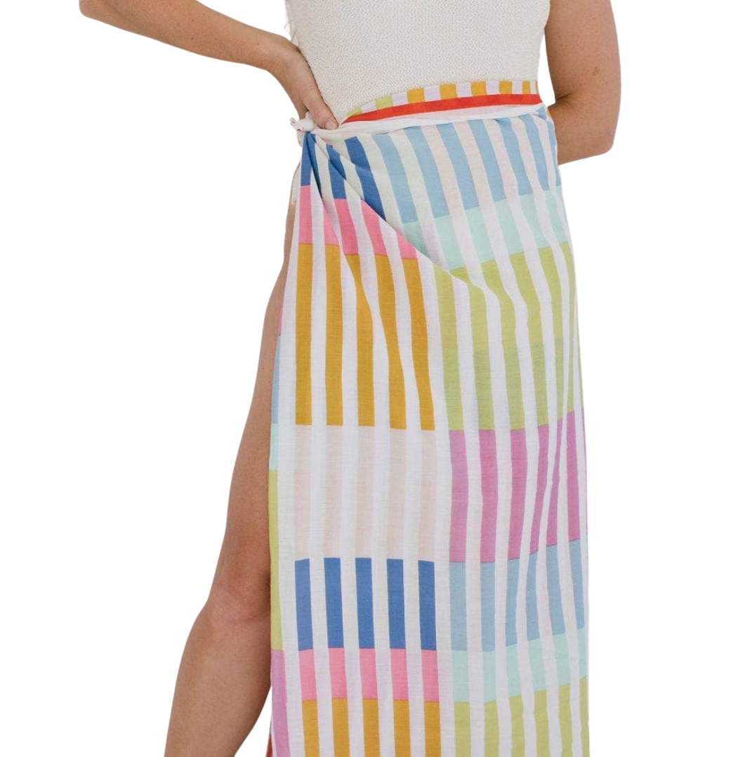 Multicolored striped skirt worn by a person on a white background