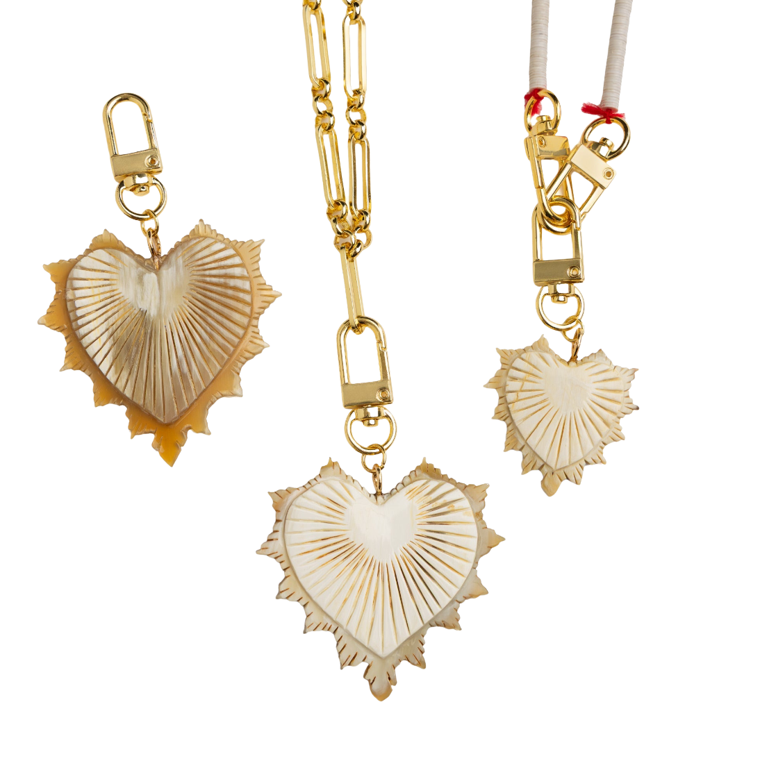 Gold and heart-shaped pendants on a white background