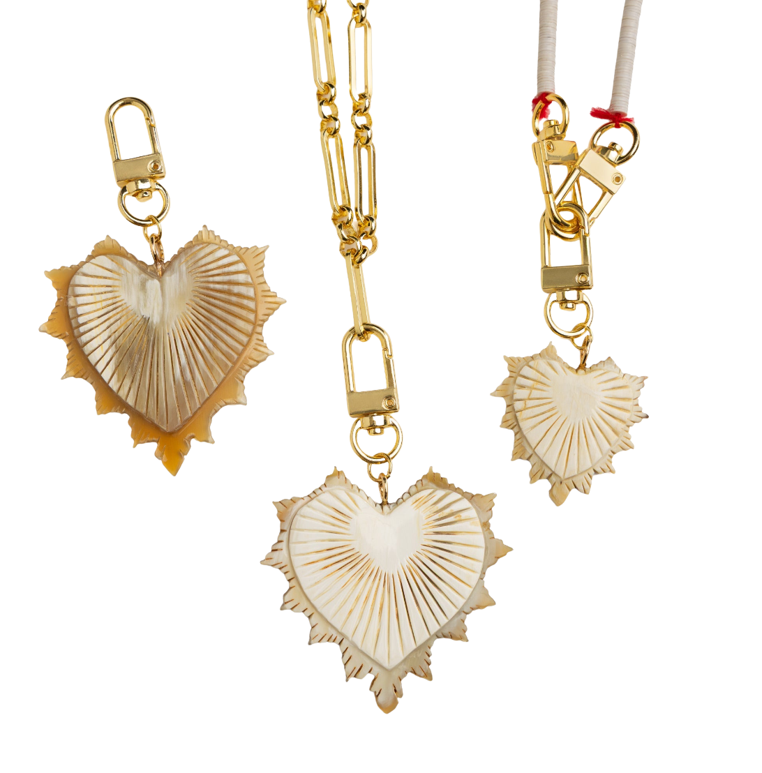Gold and shell heart-shaped keychains on a white background