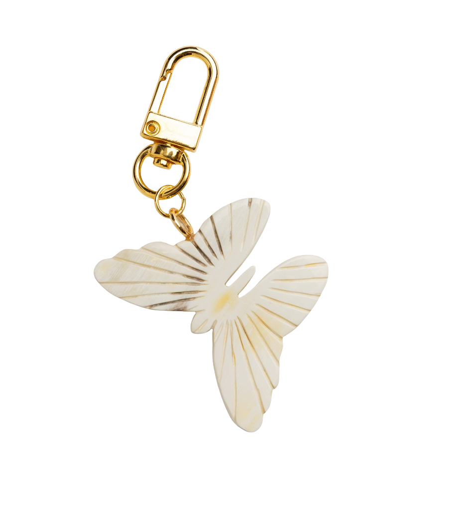 Butterfly-shaped charm with gold clasp on a white background