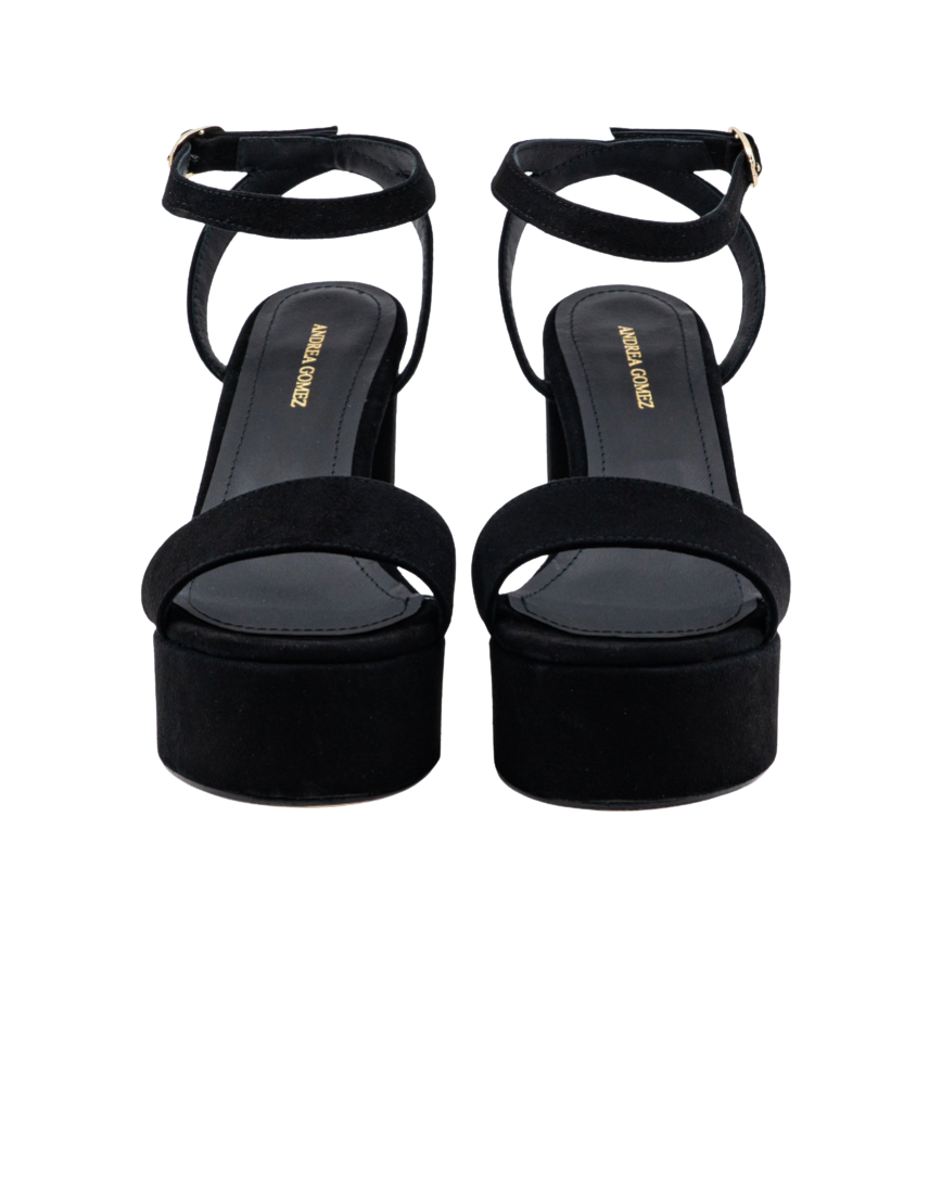 A pair of black platform sandals with ankle straps and open toes, shown from the front on a white background. The brand name 'ANNA LOUISE' is printed in gold on the insole.