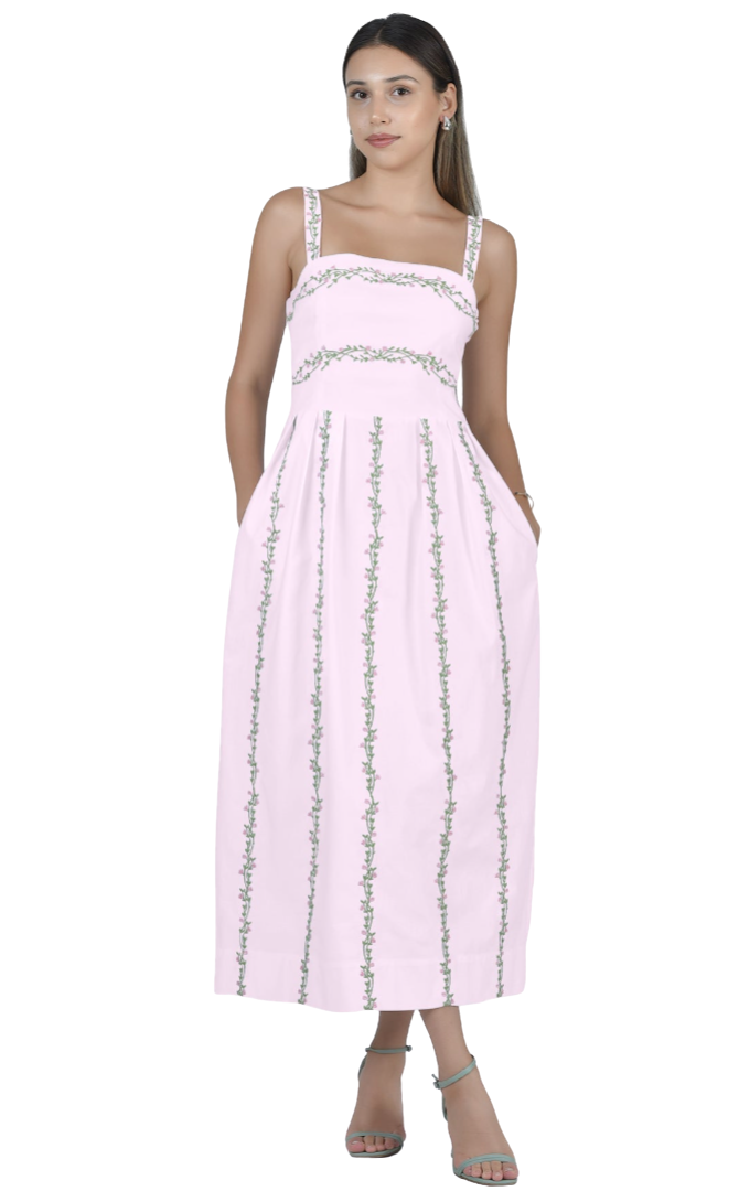 Woman wearing a pink dress with silver embellishments on a white background