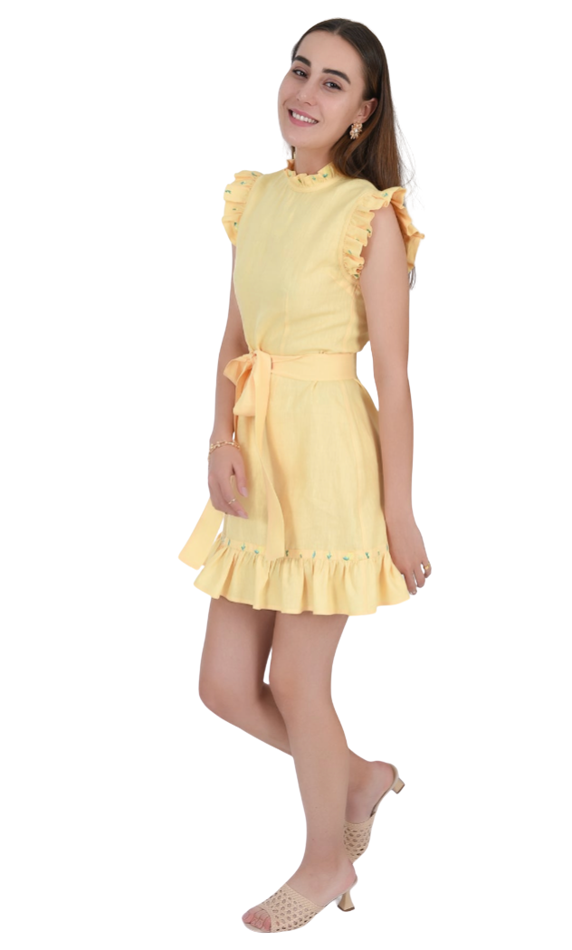 Woman wearing a yellow dress with ruffled sleeves and hem on a white background