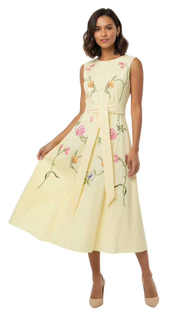 Woman wearing a light yellow dress with floral embroidery on a white background