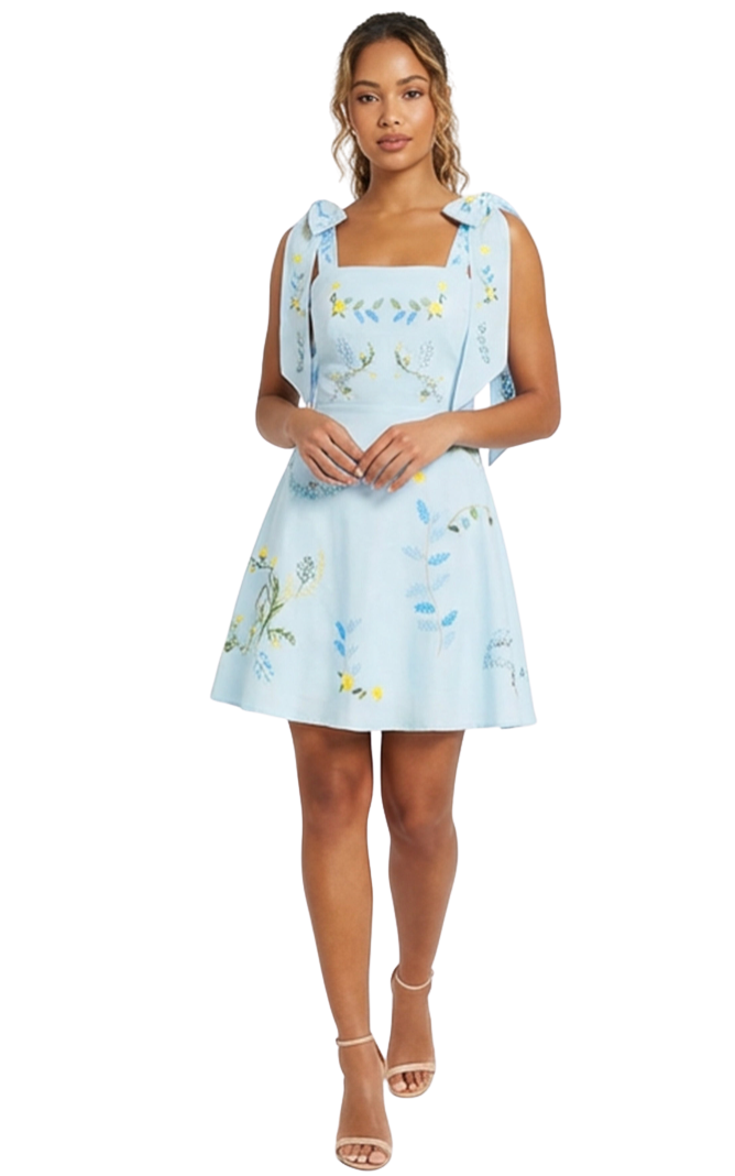 Woman wearing a light blue dress with floral patterns on a white background