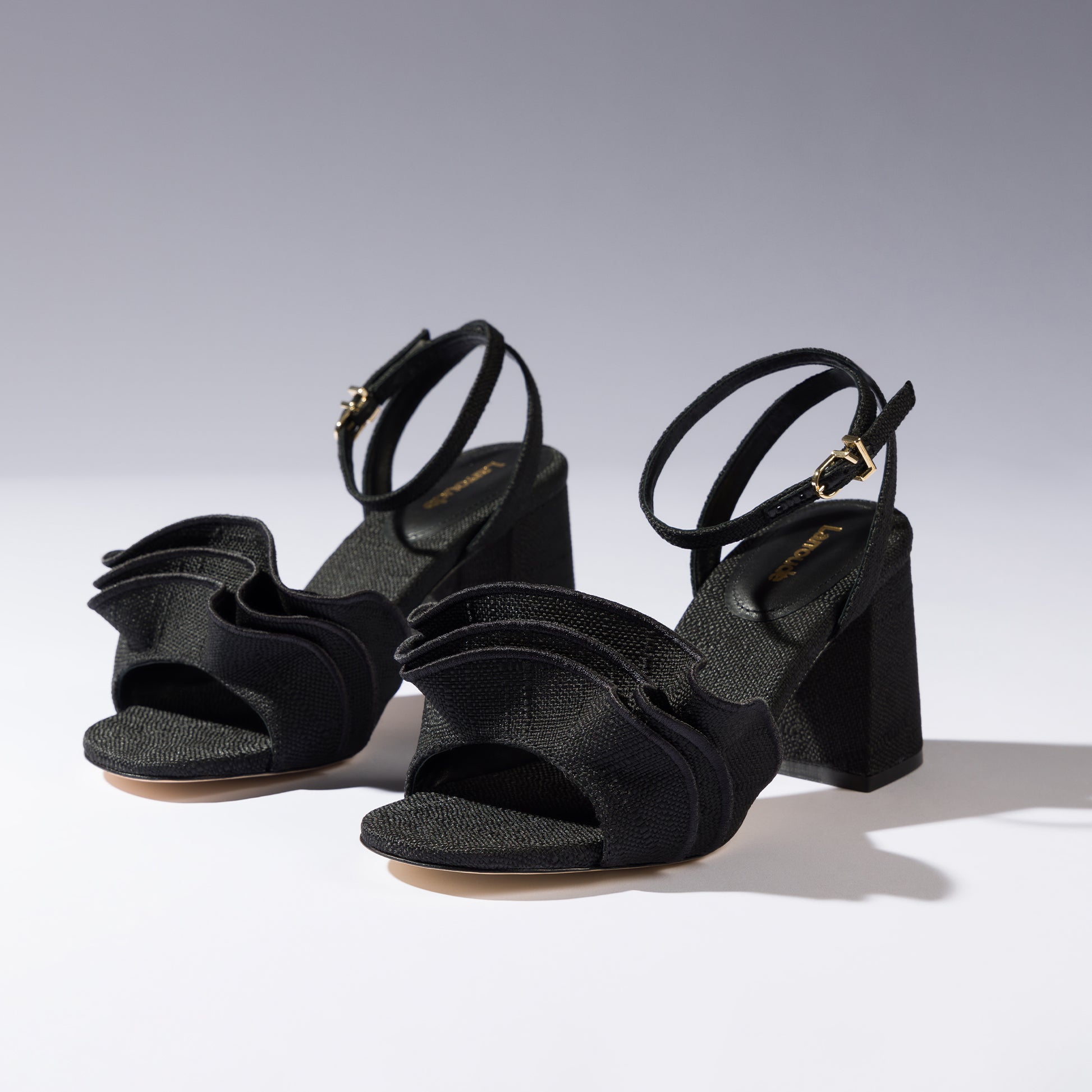 Selena Ruffle Sandal In Black Raffia by Larroudé