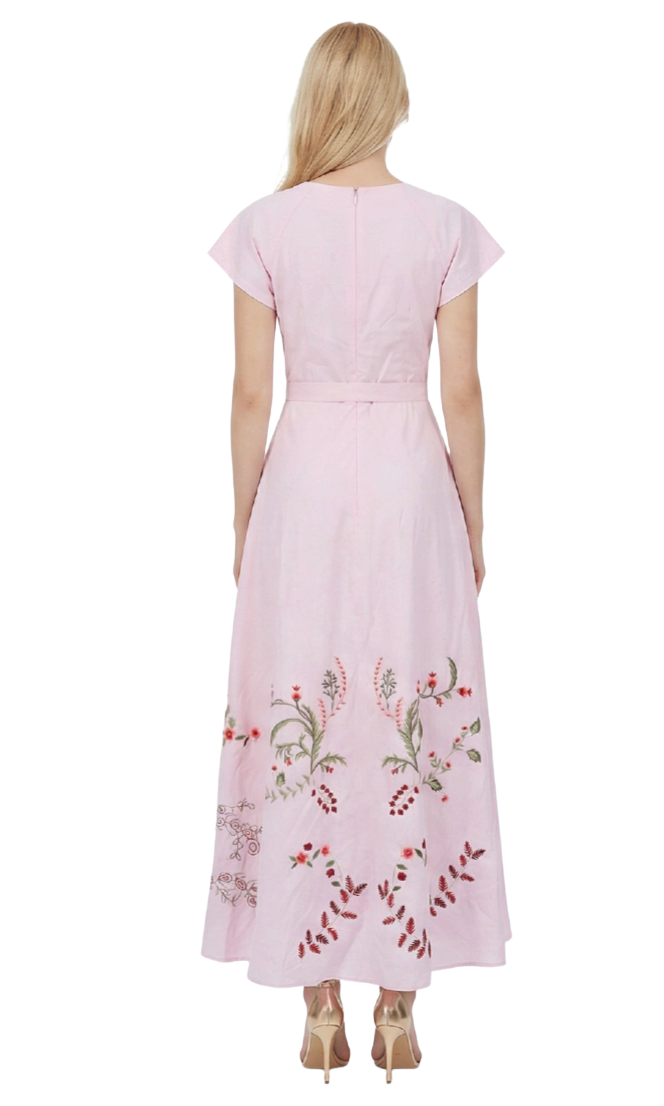 Pink dress with floral embroidery on a white background