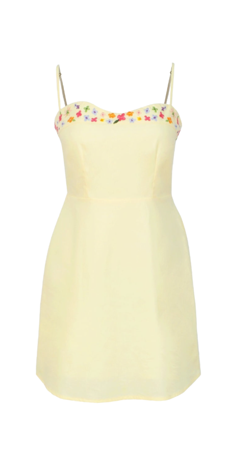 Light yellow dress with floral straps on a white background