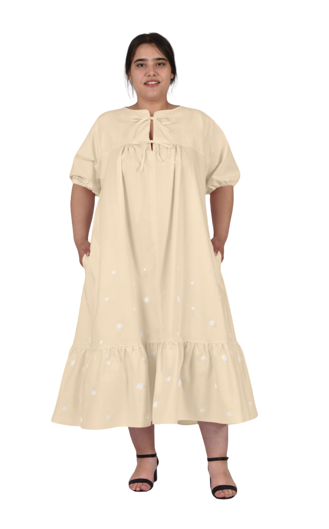 Woman wearing a beige dress on a white background