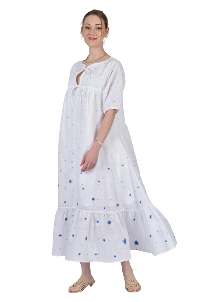 Woman wearing a white dress with blue patterns on a white background