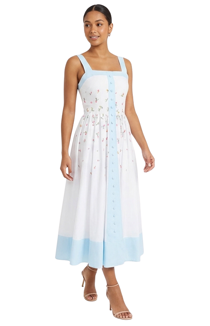 Woman wearing a white dress with blue accents on a white background