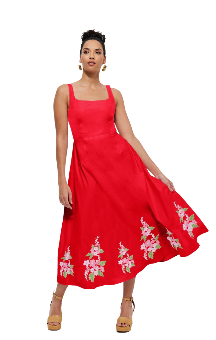 Woman wearing a red dress with floral embroidery on a white background