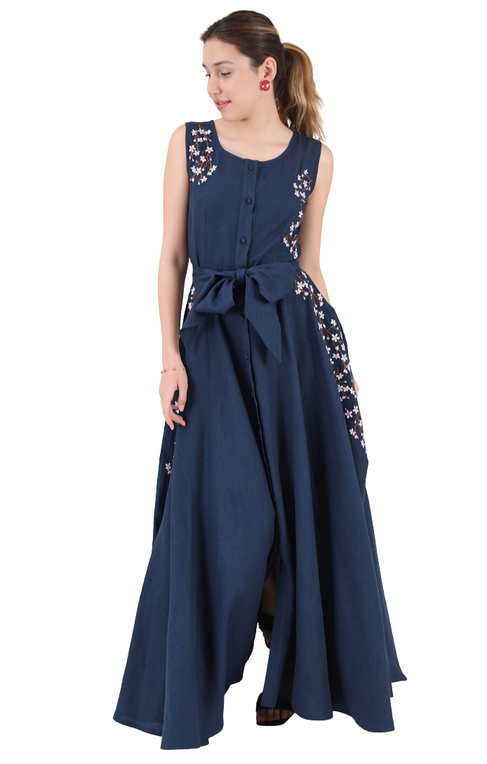 Woman wearing a long navy dress with floral embellishments on a white background