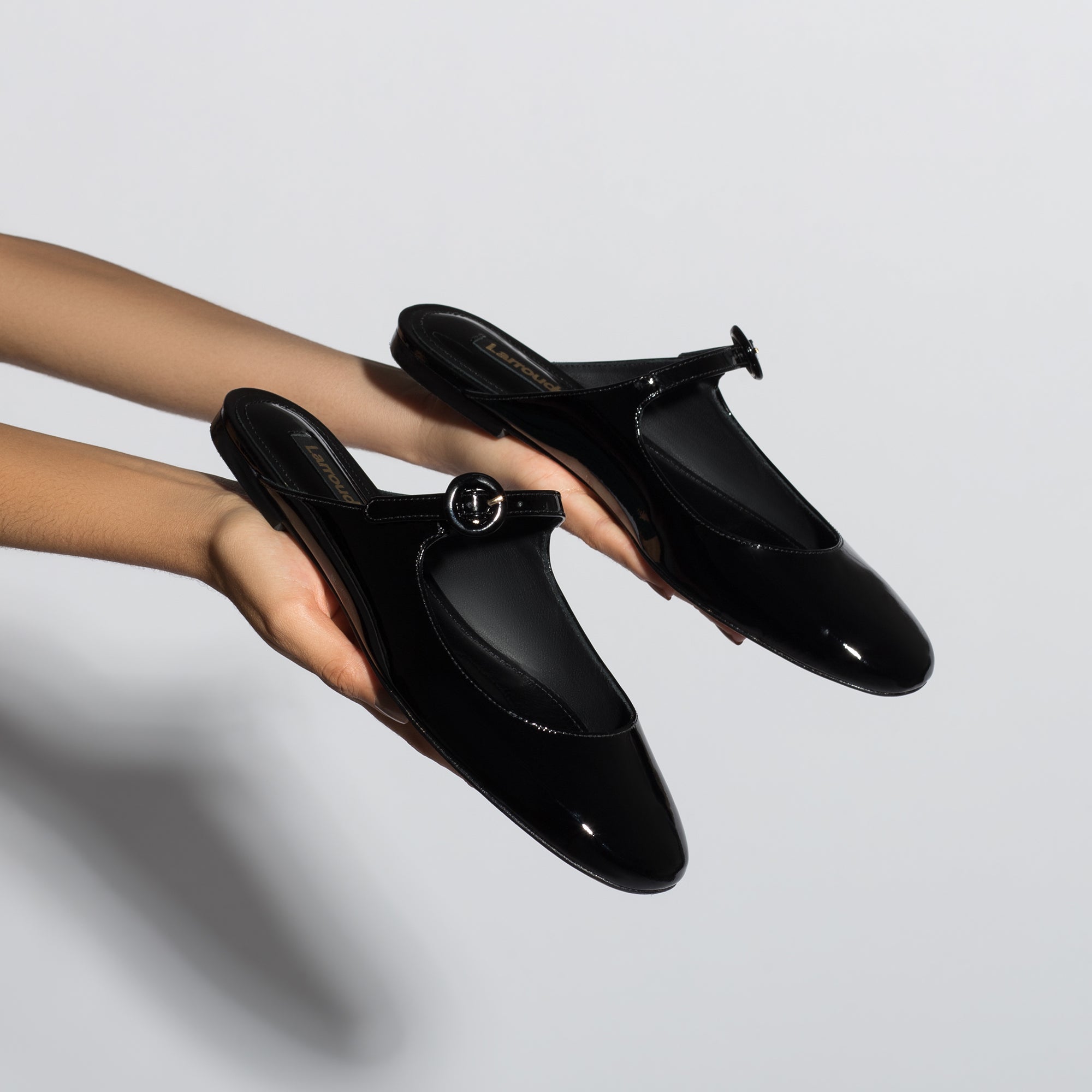 Blair Flat Mule In Black Patent Leather by Larroudé