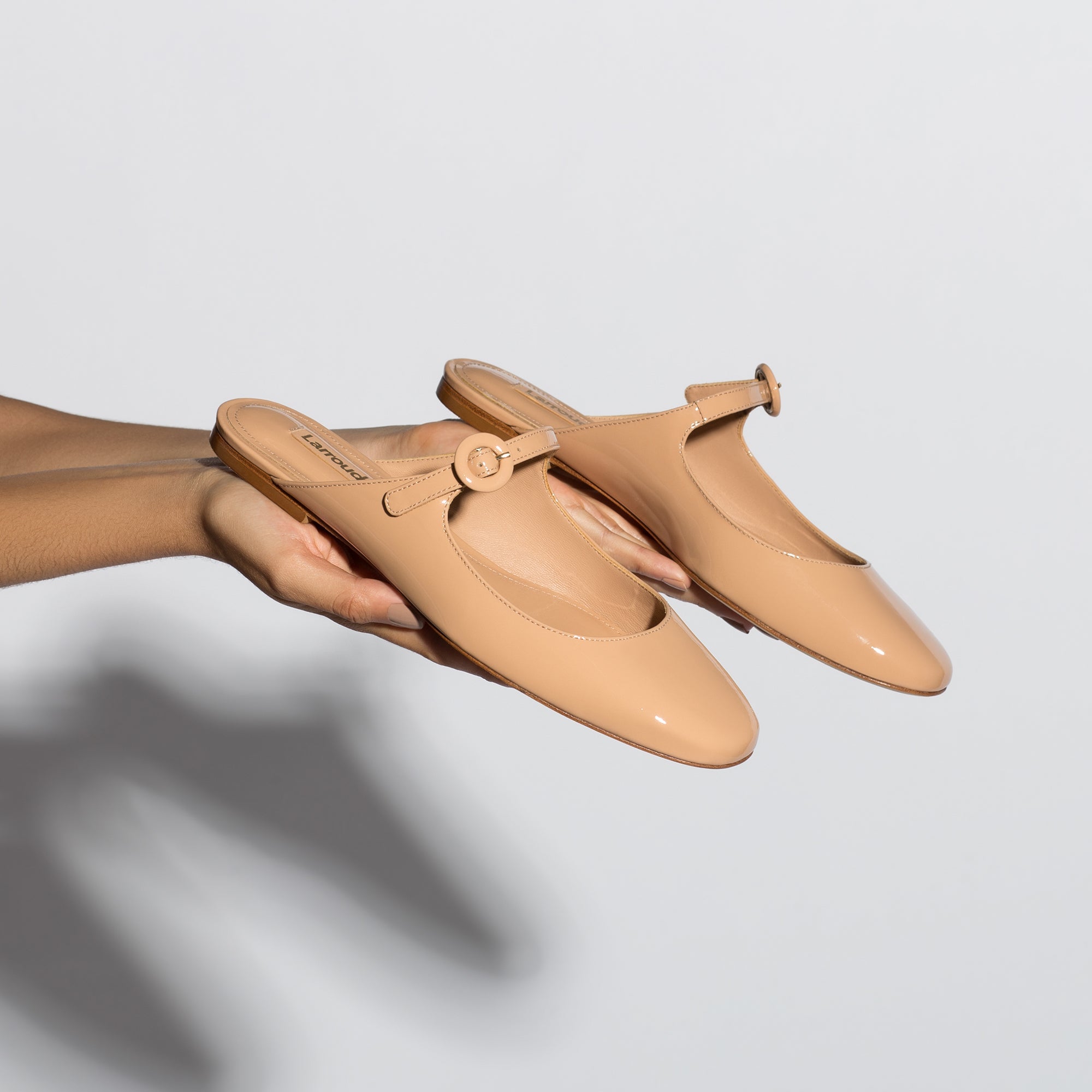 Blair Flat Mule In Tan Patent Leather by Larroudé