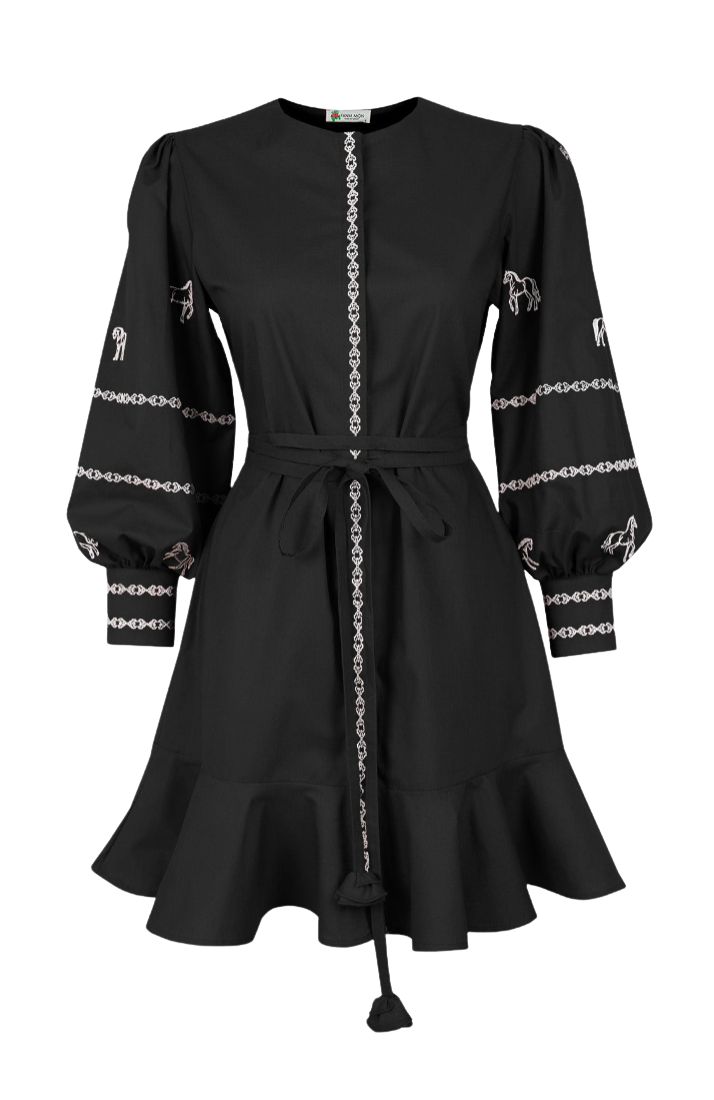 A black long-sleeve dress with decorative white embroidered patterns on the sleeves, a matching black belt with a tassel, and a central vertical chain-like embroidery detail, shown against a plain white background.