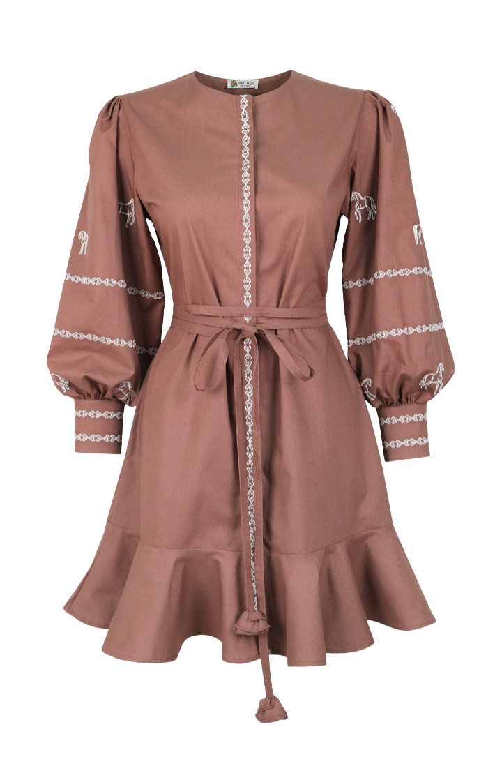 A dusty rose brown long-sleeve dress with white embroidered chain and horse motifs on the sleeves, featuring a tie waist belt and a ruffled hem.