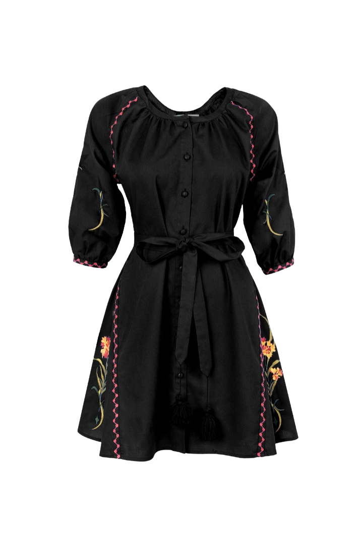 A black short-sleeve button-front dress with a tie waist, featuring colorful floral embroidery and pink zigzag stitching details, shown against a plain white background.