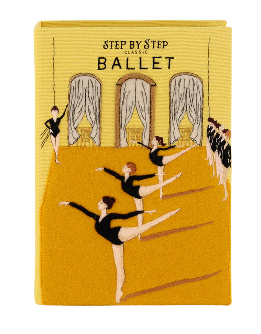 A rectangular book or notebook cover with a yellow cover, featuring an illustration of ballet dancers in a studio with the text 'STEP BY STEP CLASSIC BALLET'.
