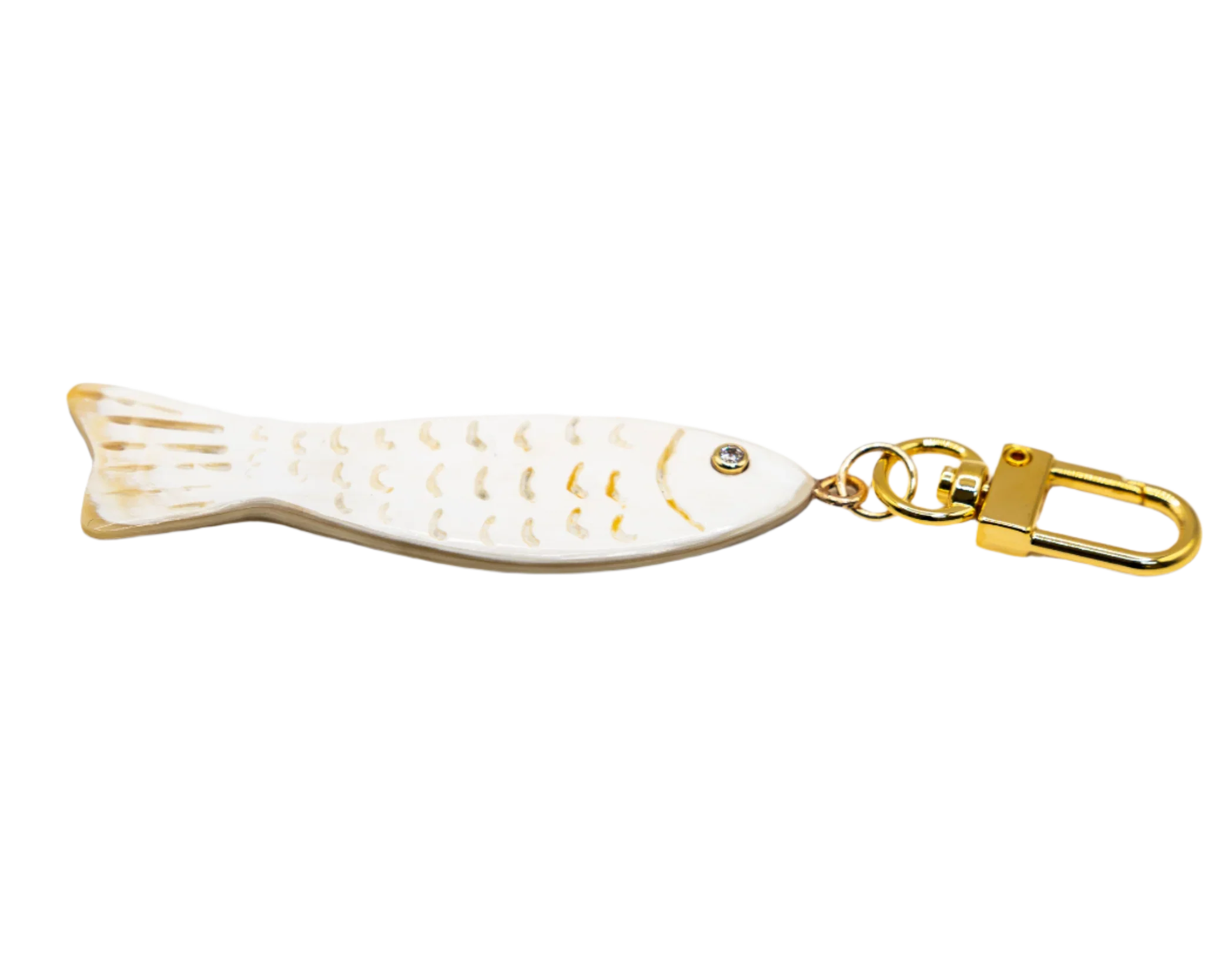 Fish-shaped keychain with gold accents on a white background