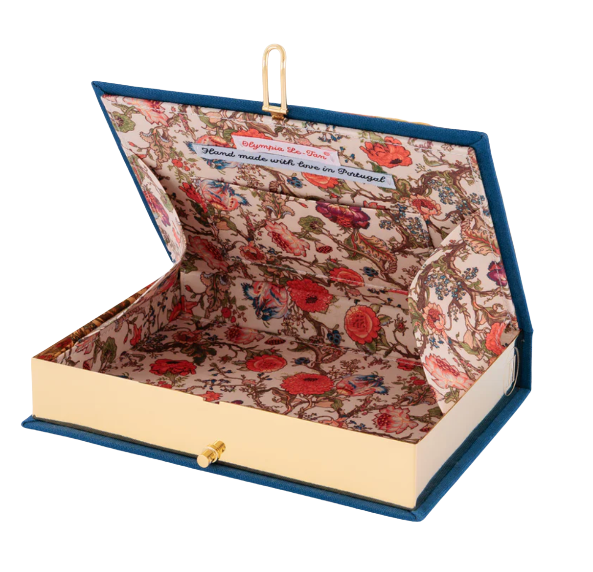 An open book-shaped jewelry box with a blue velvet cover, gold-tone clasp, and a floral-patterned interior on a white background.