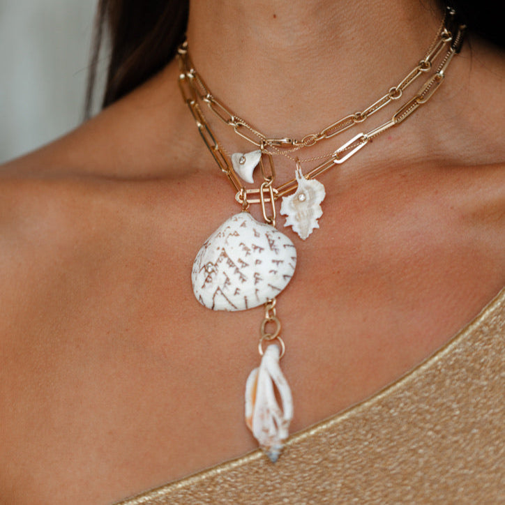 Necklace with shell pendants on a person's neck