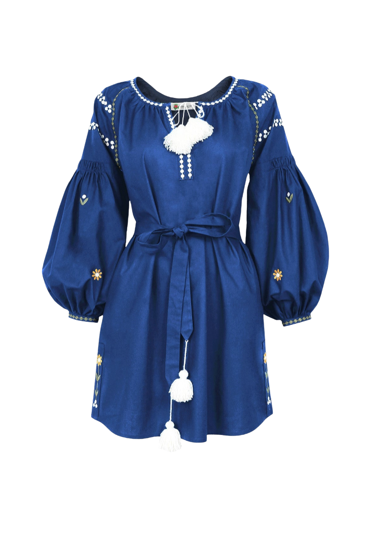 A royal blue long-sleeve dress with white embroidered details, a white tassel tie at the neckline, and a matching waist tie, shown on a plain white background.